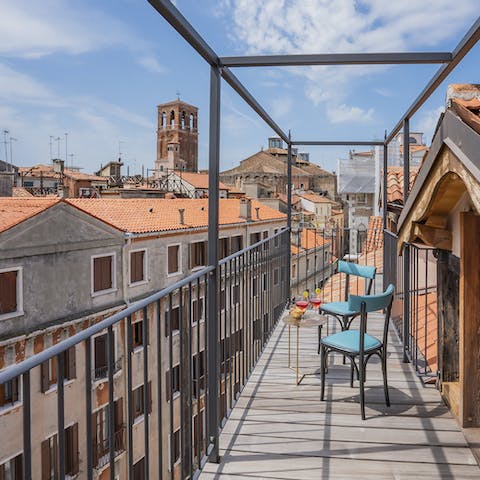 Sip Negronis and watch the sun lower behind the terracotta roofed buildings after a long day