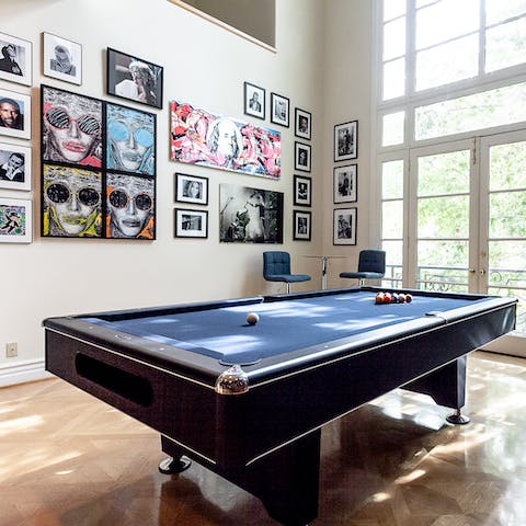 An eclectic gallery wall in the billiards room