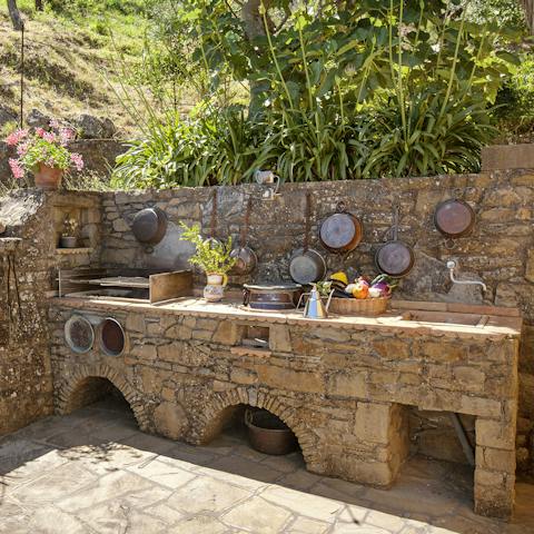 Cook up a feast at the Mediterranean style outdoor kitchen
