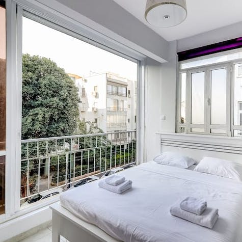 Open up the huge window in the bedroom to look out over the leafy street