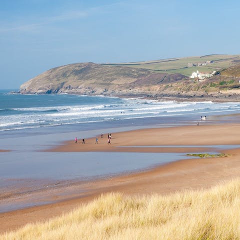 Amble along North Devon's sandy shores, just a twenty-minute drive away