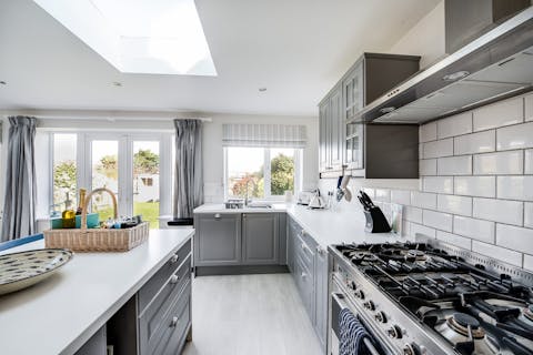 Rustle up a delicious dinner in the sleek kitchen for a cosy evening in