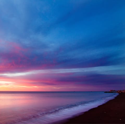 Watch the fiery sunset from Playa de Huelin