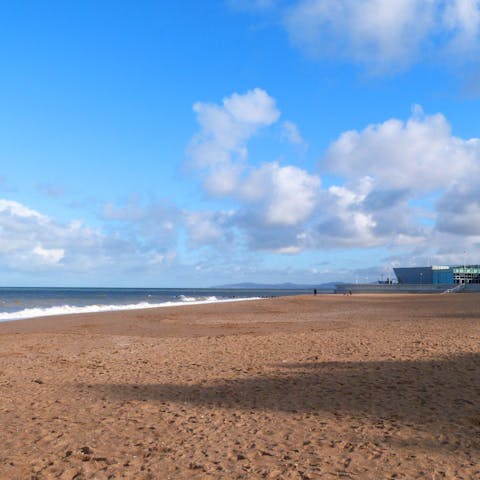 Sink your toes in the sand at Rhos-on-Sea Beach, a fifteen-minute walk away 