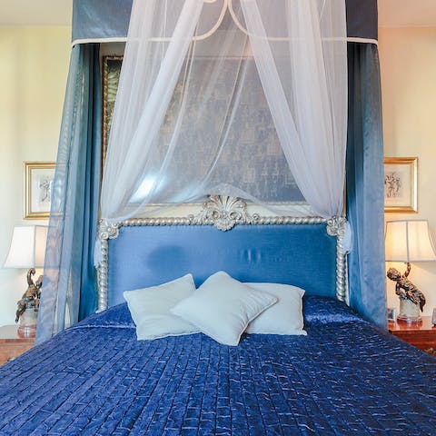 Rest easy in the sumptuous canopy bed after a long day exploring Lucca