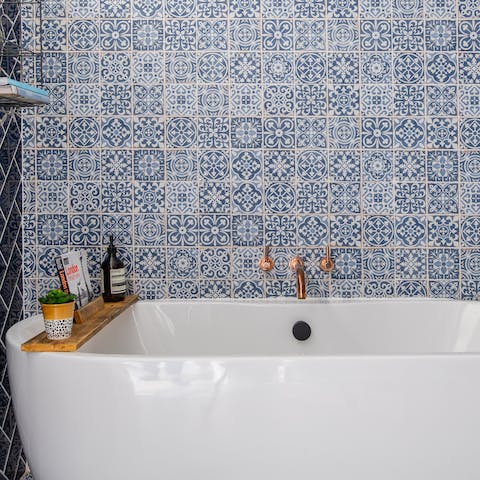 Feel all your stresses float away in the freestanding bathtub surrounded by pretty tiling