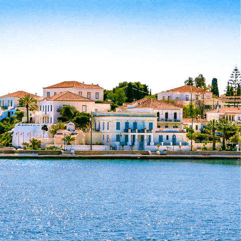 Take a seven minute water taxi to the car-free and lavishly upscale Spetses Island