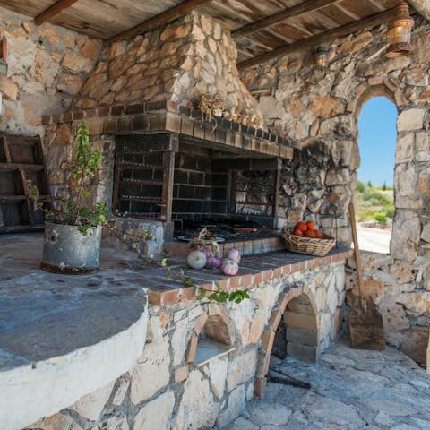 Make a fire and grill your lunch in the stone barbecue