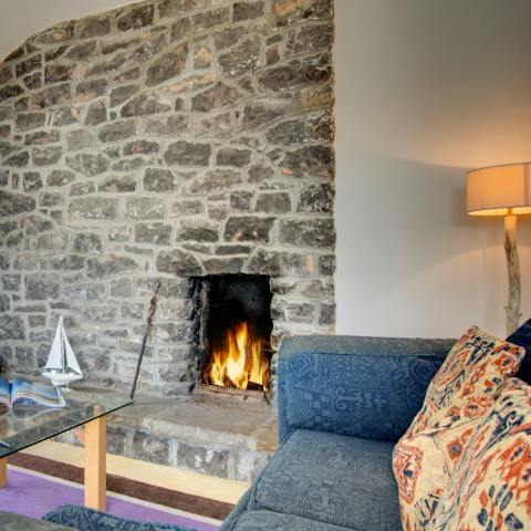 Cosy up next to the fireplace after your adventures around the Gower