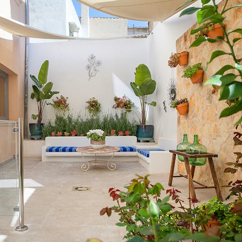  Enjoy a glass of Mallorcan wine in the plant filled courtyard with its traditional well