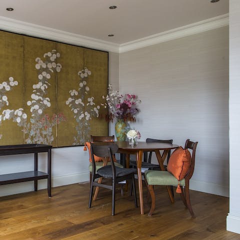 Enjoy breakfast at the mid-century dining table, with its backdrop of art