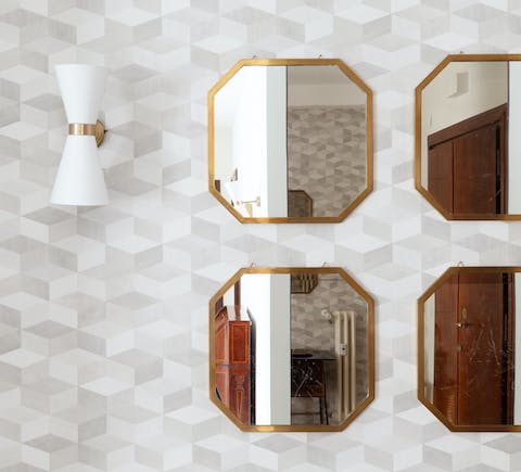 Take in the apartment's geometric patterns and stylish mirrors