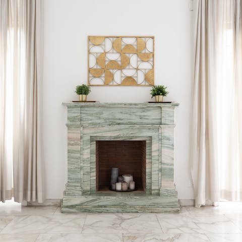 Admire the ornamental marble fireplace at the heart of the home