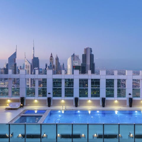 Enjoy an evening dip in the shared rooftop pool and swim with the city's skyscrapers laid out before you