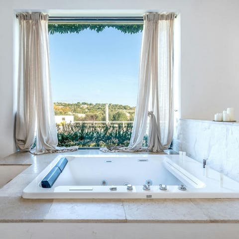 Enjoy a relaxing bubble bath in the Jacuzzi tub