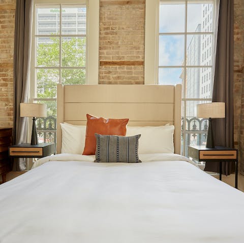 Wake up in the beautiful bedroom with its exposed-brick walls and high ceilings