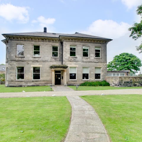 Spread out a lush picnic on the lawns in front of this stately house