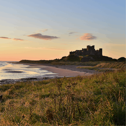 Take a sunset stroll by Bamburgh castle – a short drive away