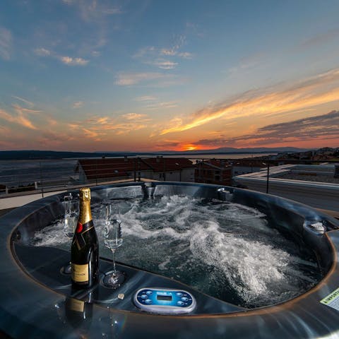 Watch the sunset with a glass of fizz in the hot tub