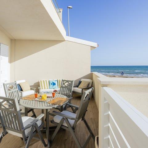 Watch the waves while you sip on a Prosecco in your private patio area
