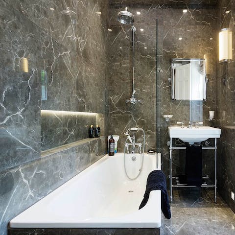 Finish the day with a soothing soak in the sleek bathroom