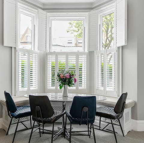 Savour a meal with family or friends at the stylish dining table in the bay window