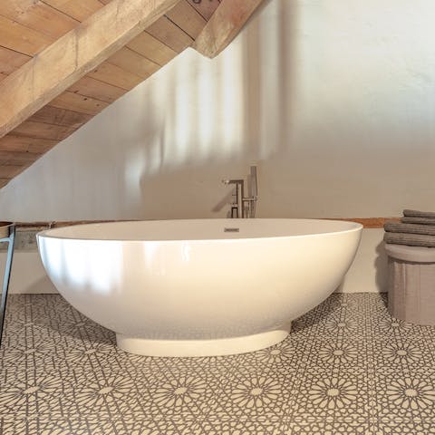 Unwind with a soak in the free-standing tub upstairs