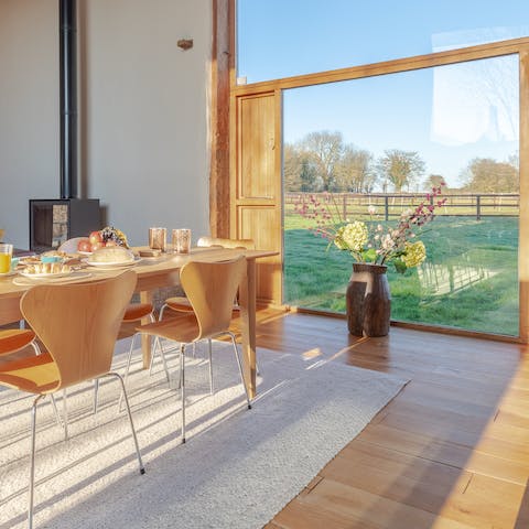 Enjoy breakfast with a view of the fields from the floor-to-ceiling windows