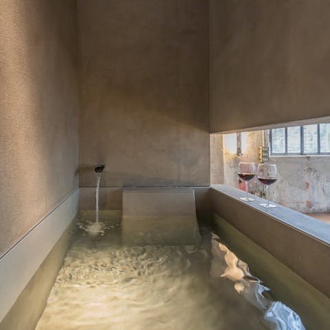 Soak with a glass of local Cabalie in the unique bathtub