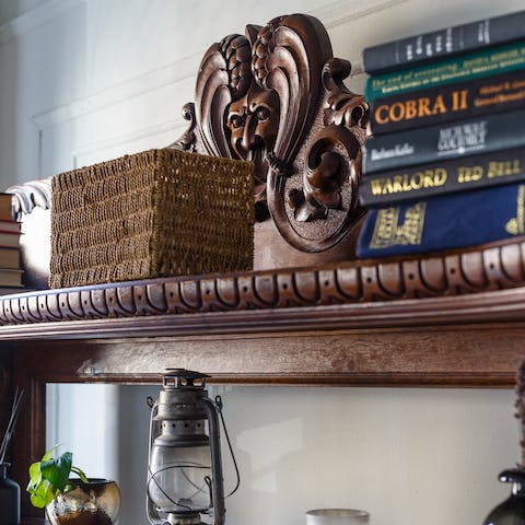 Browse the selection of books on the intricately carved shelves