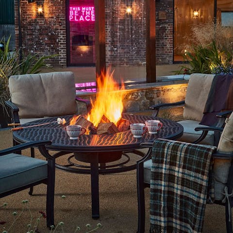 Get toasty beside the firepit on the shared courtyard
