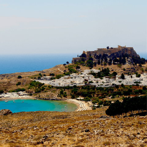 Explore the picturesque town of Lindos and hike up to the famous clifftop acropolis