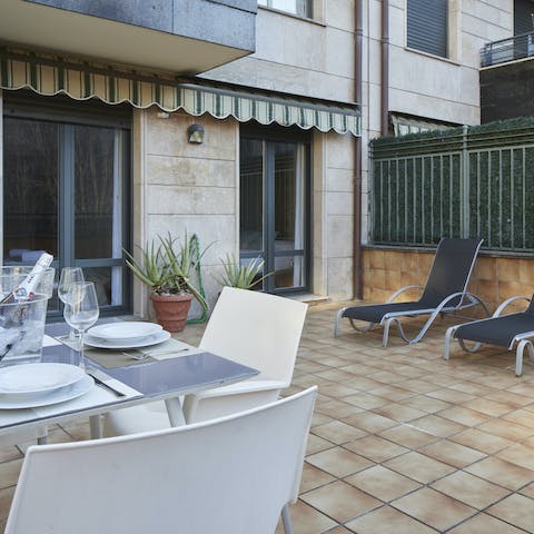 Cook up dinner in the modern kitchen and serve to guests seated on the terrace