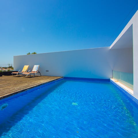 Slip into the pristine swimming pool in the heat of the day