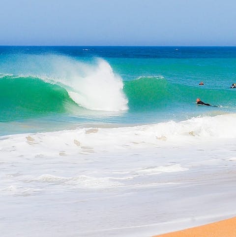 Head to the beach, a ten-minute walk away, and catch some waves