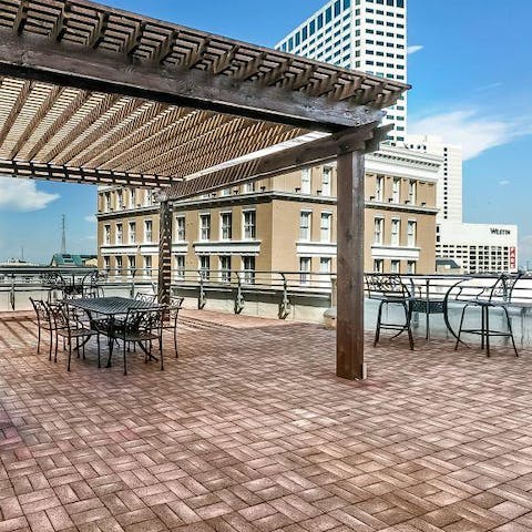 Relax with a cool drink, taking in the city views from the communal roof terrace