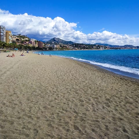 Step onto the sand at Malagueta beach, ten minutes away on foot