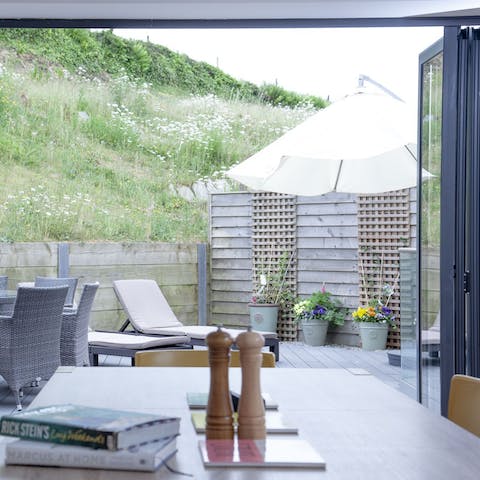 Throw open the bifold doors and let the sea air into the living space