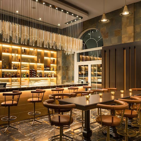 Share cocktails at the resort's stylish golden bar