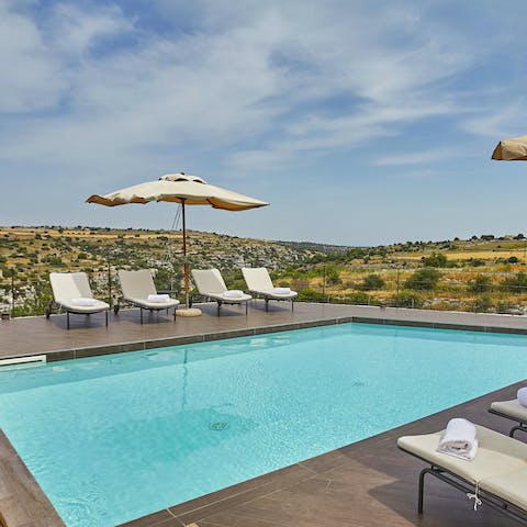 Spend the day lounging by the azure pool surrounded by Sicilian countryside