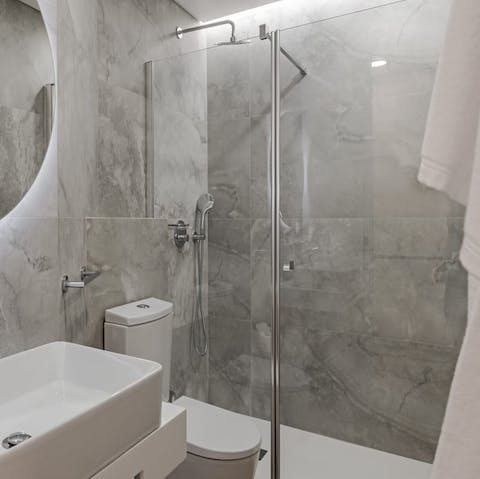 Start mornings with a relaxing soak under the bathroom's rainfall shower