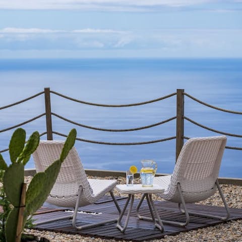 Gaze out at the seemingly infinite blue ocean from your patio