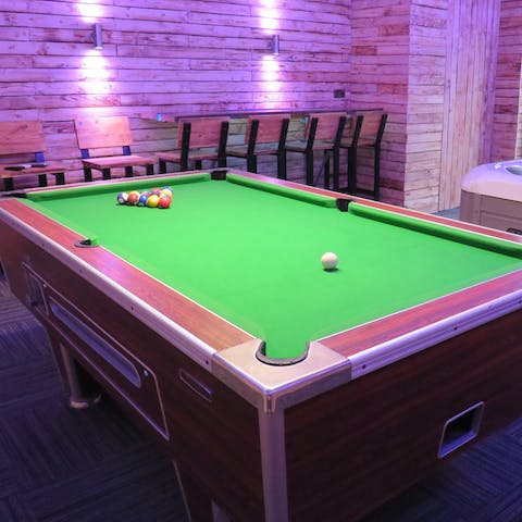 Get competitive over a game of pool in the entertainment room 