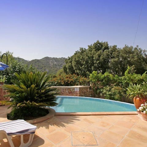 Enjoy the serenity of the pool with a view of the Mallorcan hills