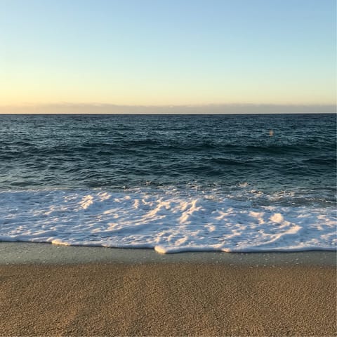 Watch the waves crashing against the shore at Fonte da Telha