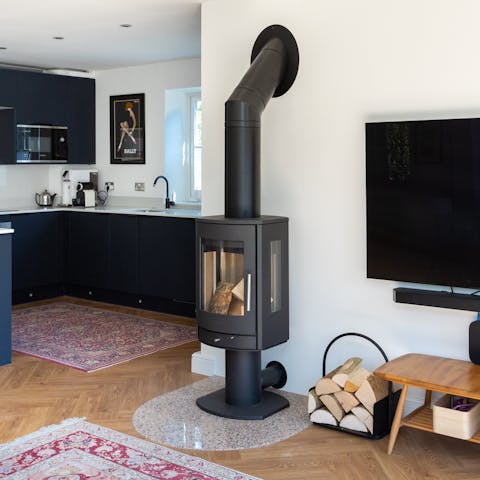 Chuck some logs on the contemporary wood-burning stove and cosy up for the evening