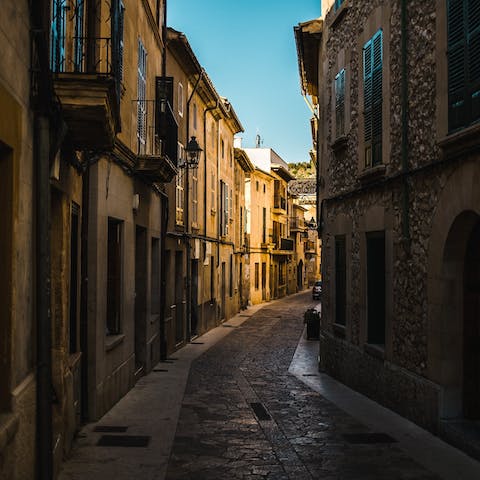 Stroll the romantic, cobbled streets of Pollença – a thirteen-minute drive away