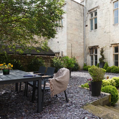 Fire up the barbecue for an alfresco evening meal in the pretty walled garden