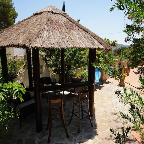 Enjoy an afternoon drink under the straw pergola