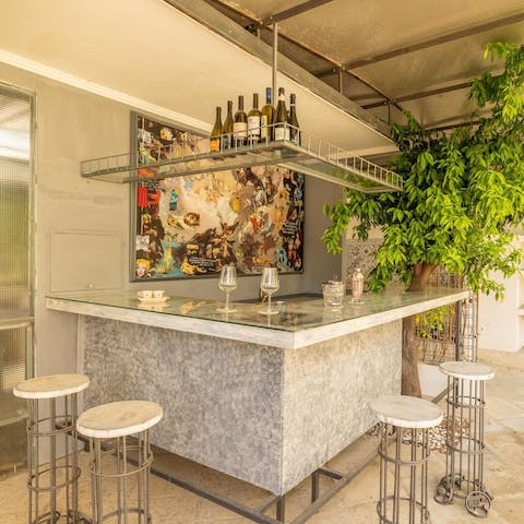 Enjoy a drink at the outdoor bar as you enjoy the Mediterranean heat